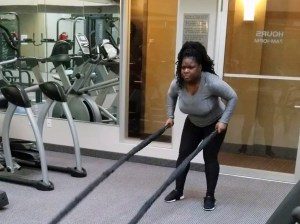 client Niray using battle ropes